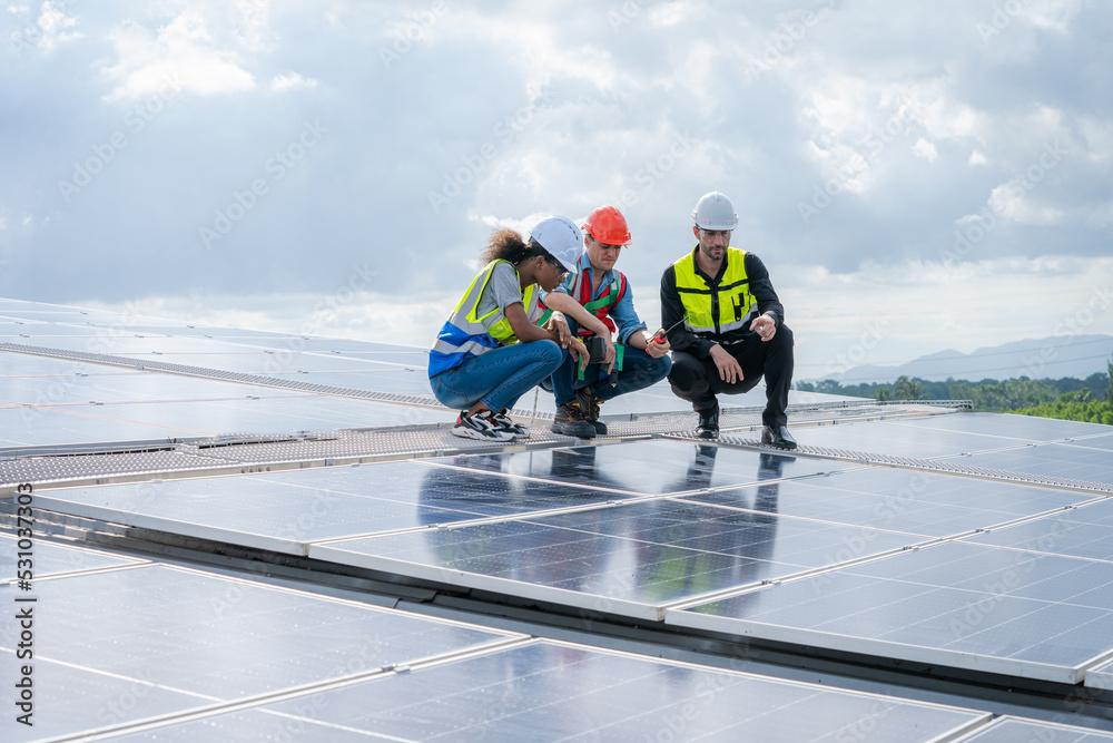 Engineers checking the operation of the system solar cell on an building in an residential area,Photovoltaic module idea for clean energy production. Engineers checking the operation of the system solar cell on an building in an residential area,Photovoltaic module idea for clean energy production.