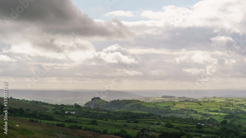 Time lapse of welsh landscape with beautiful play of light and distant Carreg Cennen Castle, Brecon Beacons National Park, Wales, United Kingdom photo