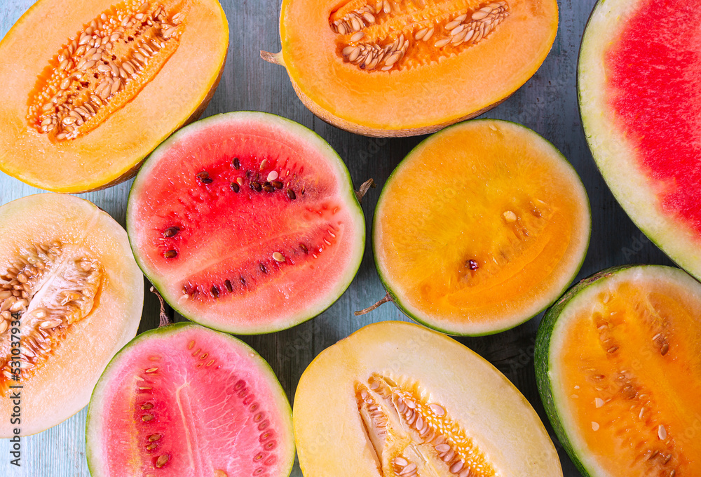 Variety of melons and water melons on wooden surface. Food backgrounds.