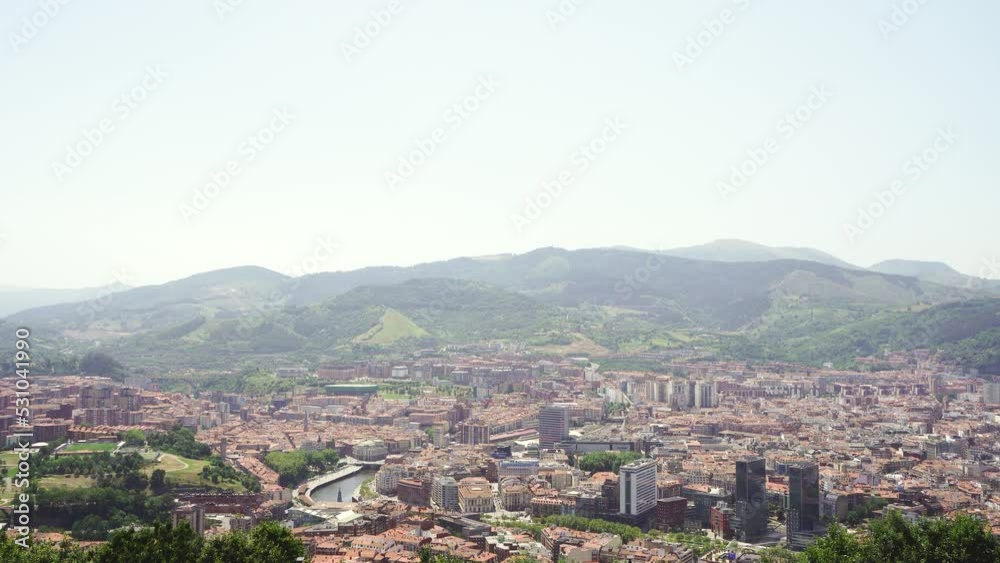 Top panoramic view of Bilbao city. Perspective from above of the city. In front the old town and the river Nervion, in background the mountains that surrounding the city. Foggy day. Static video Top panoramic view of Bilbao city. Perspective from above of the city. In front the old town and the river Nervion, in background the mountains that surrounding the city. Foggy day. Static video