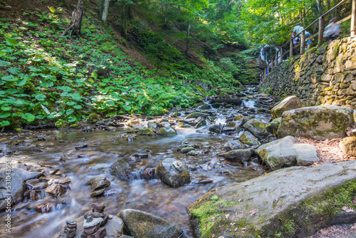 Amazing sunny summer landscape with beautiful river near the Shypit waterfall in Carpathian mountains,Nature travel background suitable for wallpaper or cover photo