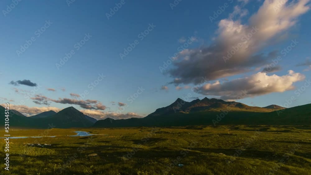 Time lapse of a golden sunset over the mountains of Cuillins on Skye, Scotland, United Kingdom Time lapse of a golden sunset over the mountains of Cuillins on Skye, Scotland, United Kingdom