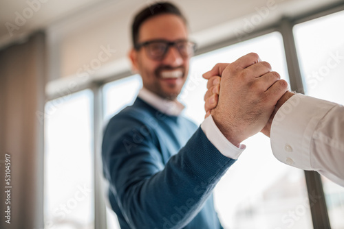 Photography Closeup picture of two colleagues, acknowledging each other after a successful project