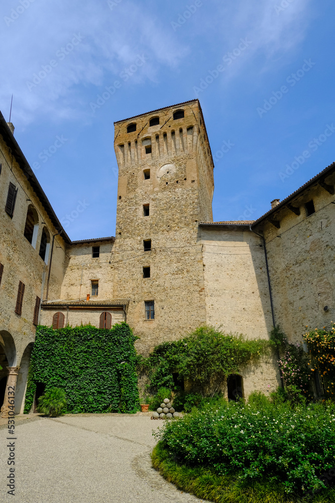 tower and of the palace Castle, Castello of Montechiarugolo, Parma, Italy with plants and monuments, doors, and windows