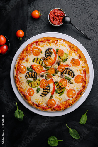 vegetarian pizza with zucchini, eggplant, mushrooms and tomato