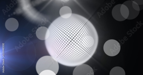 Image of mirrorball and white bokeh lights on dark background photo