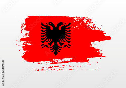 Modern style brush painted splash flag of Albania with solid background