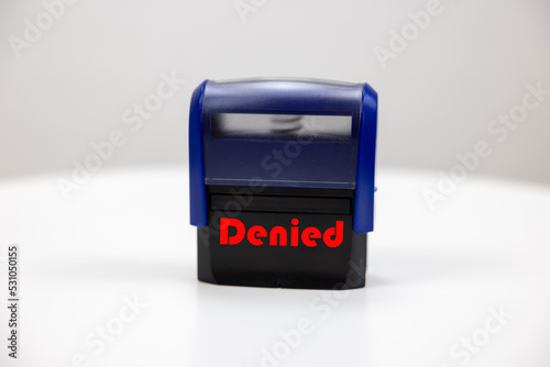 A blue black stamp with text on it espressing something is accepted or denied. Make a decision, which influences the future. photo