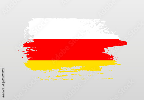 Modern style brush painted splash flag of South Ossetia with solid background