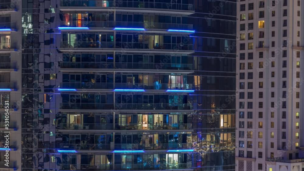 Windows of apartment buildings at night timelapse, the light from the windows of houses