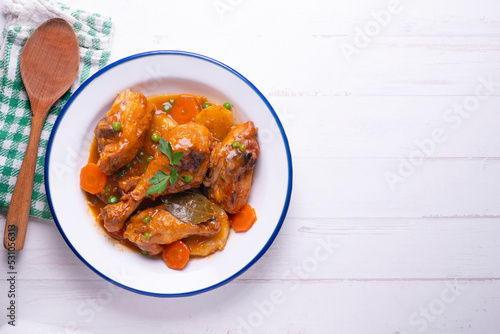 Chicken with vegetable sauce, carrots, peas and potato. Traditional Spanish dish recipe.