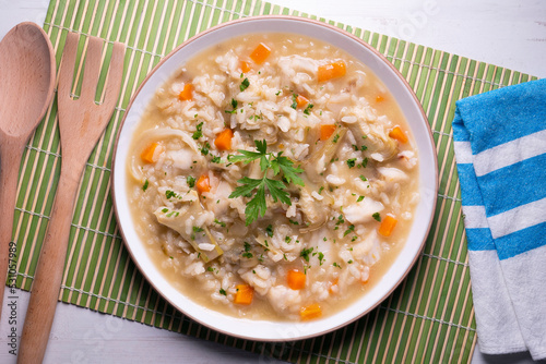 Soupy rice with artichokes and carrots. Typical Spanish gastronomy platter.