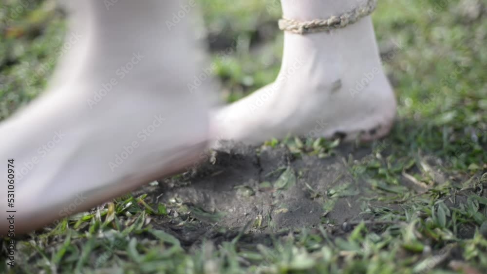 woman´s feet stepping in muddy grass and stretching woman´s feet stepping in muddy grass and stretching