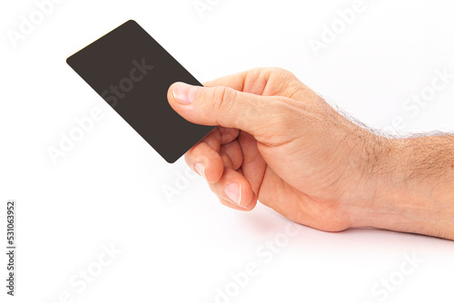 The man is holding a credit card in his hand.