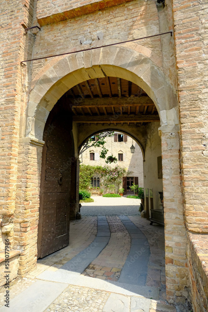 Montechiarugolo, Italy: entrance of the Castle, Castello of Montechiarugolo, Parma, Italy through the arches. Travel, tourism