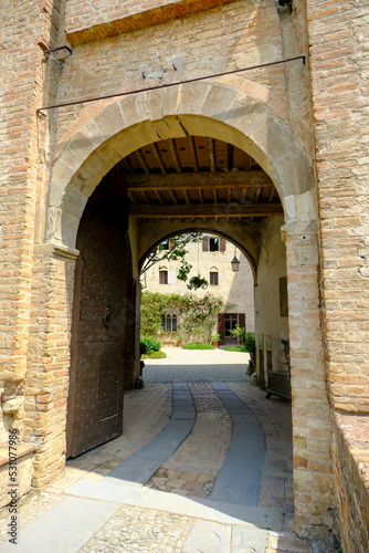 Fototapeta Naklejka Na Ścianę i Meble -  Montechiarugolo, Italy: entrance of the Castle, Castello of Montechiarugolo, Parma, Italy through the arches. Travel, tourism