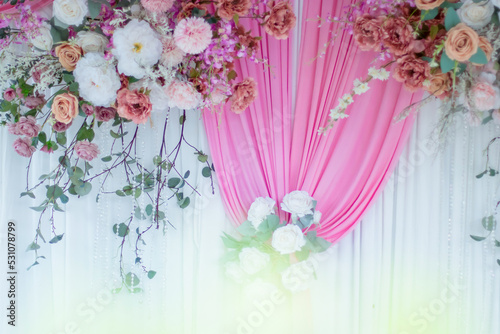 Beautiful flowers decorate the scene in the wedding.