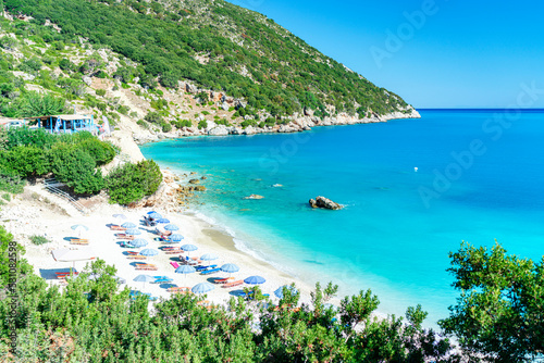 High angle view of beach umbrellas on the idyllic Vouti beach framed by lush plants, Zola, Kefalonia, Ionian Islands, Greek Islands, Greece