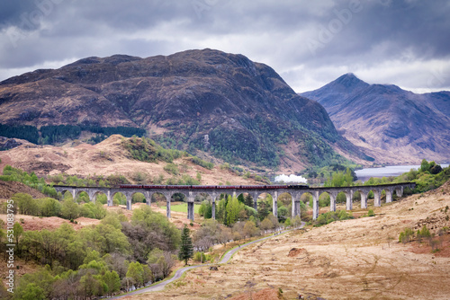 The Jacobite steam train travelling to Mallaig from Fort William, on the Glenfinnan Viaduct, Highlands, Scotland photo