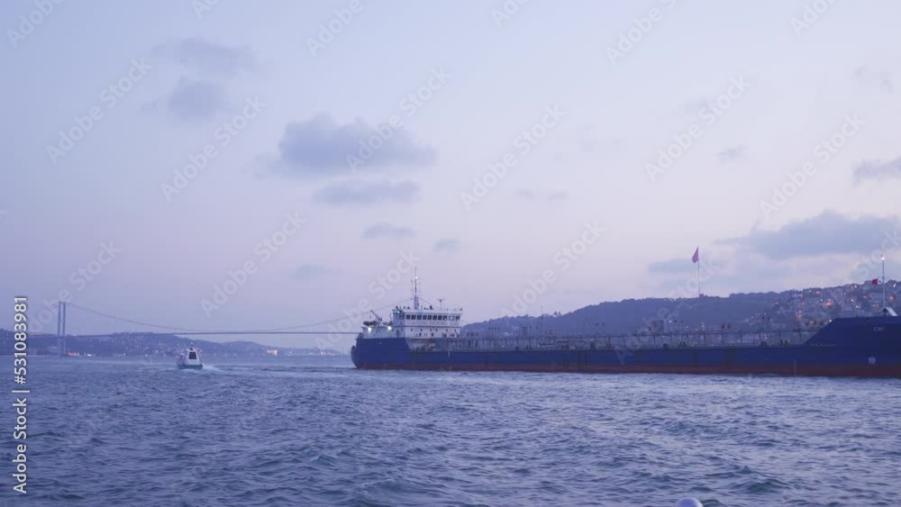 Big ship passing through the strait.
A large commercial ship is passing through the strait. There is a bridge and city view in the background.
Big ship passing through the strait.
A large commercial ship is passing through the strait. There is a bridge and city view in the background.