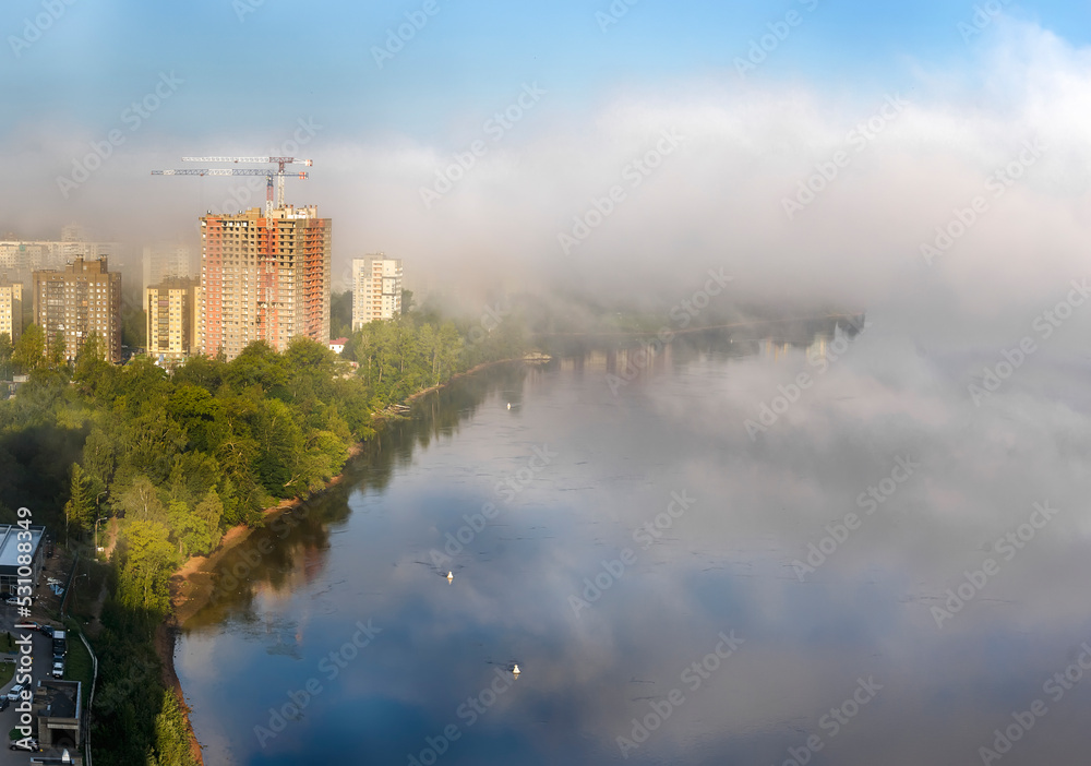 Morning fog over the city and the Neva river.