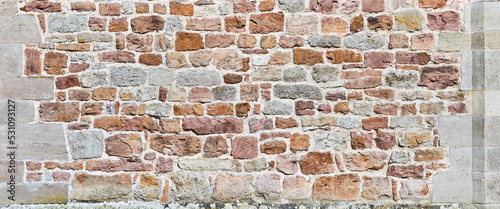 Old un plastered castle wall, close-up.