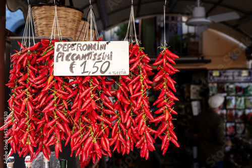 Calabrian red pepper in Tropea street market. Traditional unique ingredient in Calabria's cuisine, symbol of region. Travel in Calabria concept, south Italy. photo