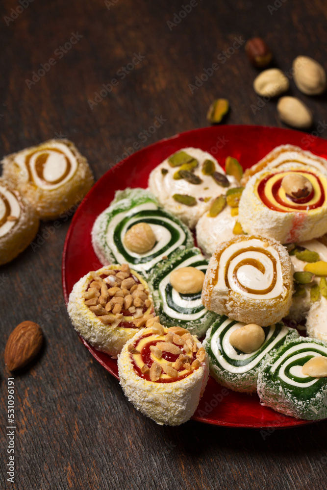 Assorted oriental sweets on a red plate Assorted oriental sweets on a red plate