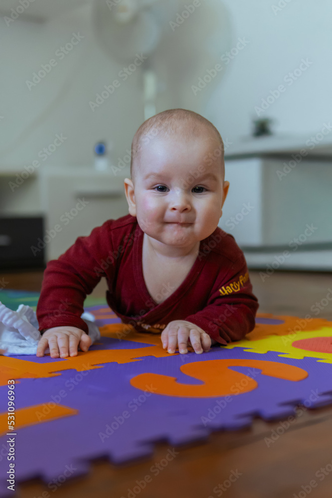 Cute baby crawling on the floor looking to the camera Cute baby crawling on the floor looking to the camera