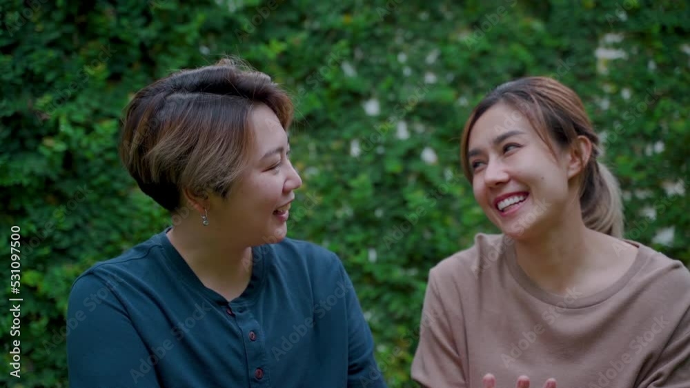 4K, Two Asian lovers are sitting together and teasing with love and happiness in their new backyard where they live happily ever after. Love and friendship of LGBTQ couples 4K, Two Asian lovers are sitting together and teasing with love and happiness in their new backyard where they live happily ever after. Love and friendship of LGBTQ couples