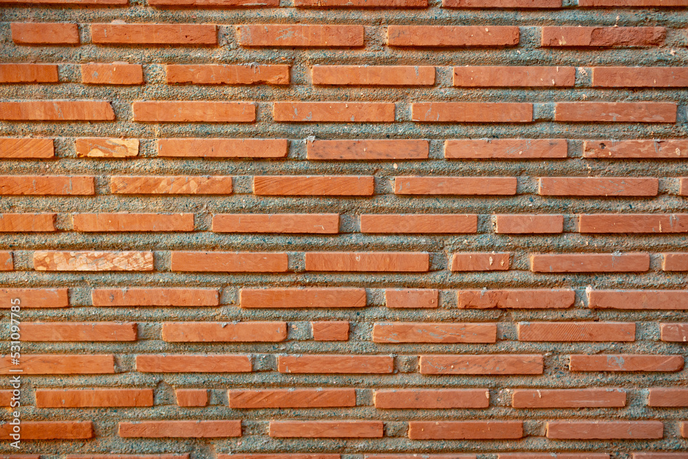 Outdoor brick wall made from narrow long bricks Outdoor brick wall made from narrow long bricks