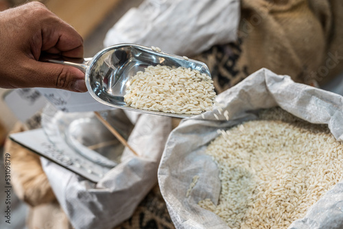 Taking out Carnaroli rice from a sack photo