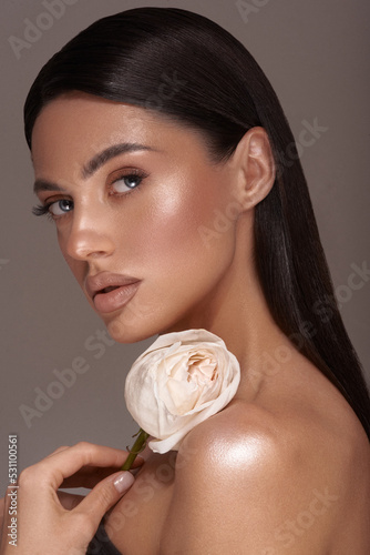 Brunett Woman with flower glowing skin