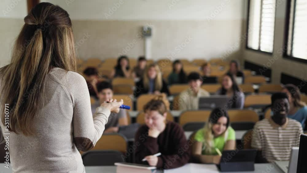 Young students listening a lesson in high school - School education concept