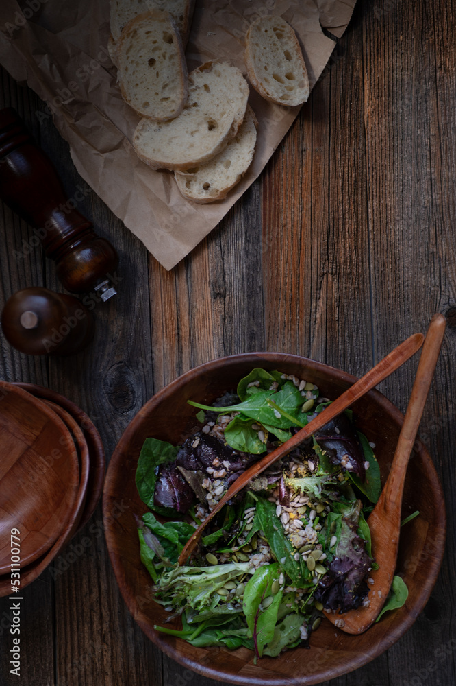 Vegan greens salad on wooden background, overhead, copy space