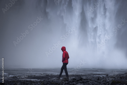 Walking in Front of Iceland Waterfall