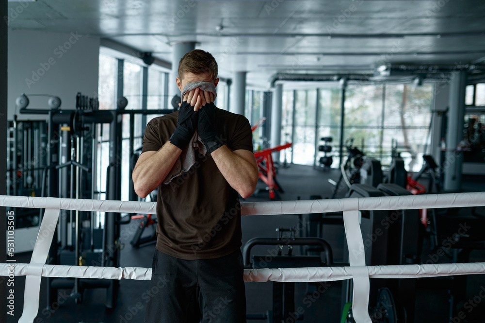 Tired boxer with towel in the ring Tired boxer with towel in the ring