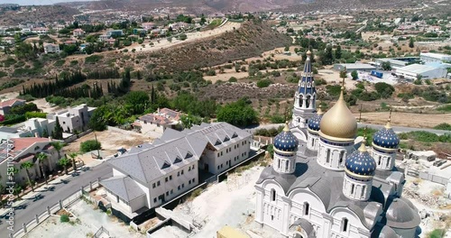 Aerial drone footage of the construction of Russian orthodox church Saint Nicholas in Limassol, Cyprus.Reveal scene of the golden dome, bell tower, cross of religious russian architecture from above.