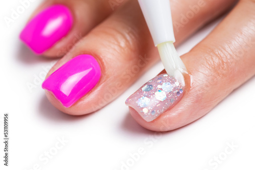 Cuticle gel. Master applies cuticle gel in the beauty salon. Professional care for hands.
