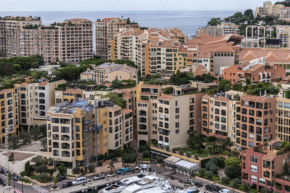 Fototapeta premium Panoramic view of Fontvieille - district of Monaco with boats and a high-rise apartment complex. Principality of Monaco, French Riviera, Western Europe.