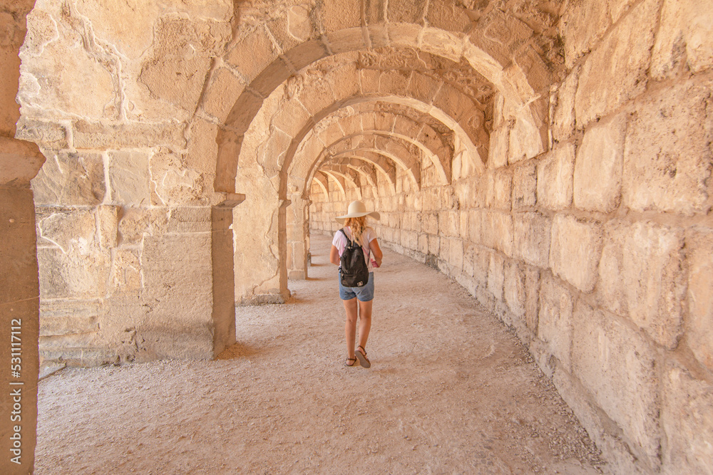 Woman tourist  visiting The Theatre of Aspendos Ancient City in Antalya