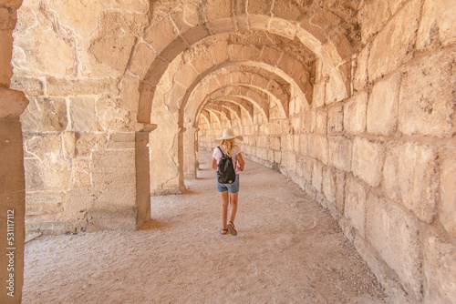 Woman tourist  visiting The Theatre of Aspendos Ancient City in Antalya