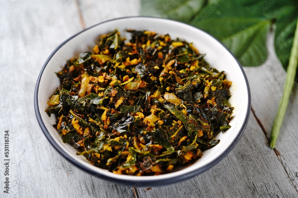 Green beans leaves stir fried with coconut and turmeric, selective focus