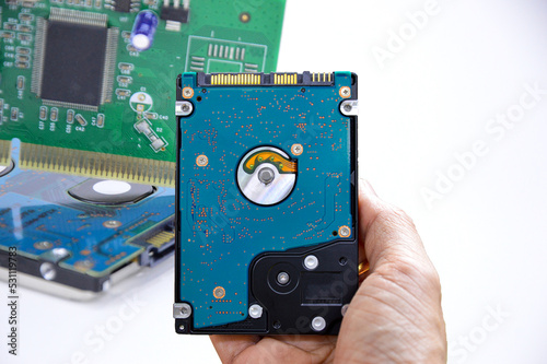 Hard disk drives are still widely used. hard drive in hand (Cut path included in this picture)