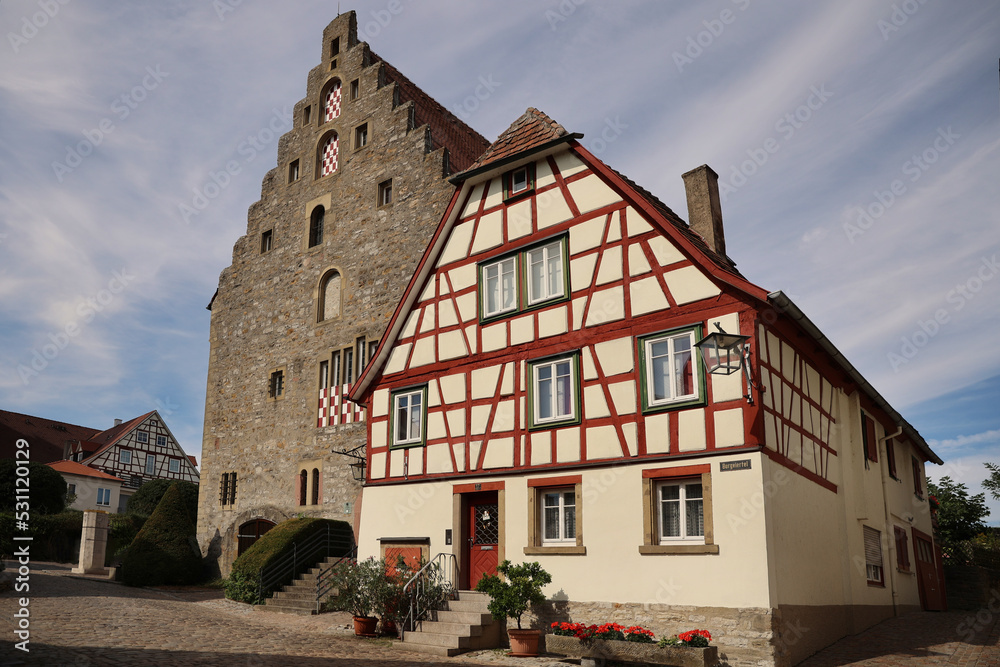 Obraz premium Market square in typical German village with Fachwerk houses and big warehouse in summer