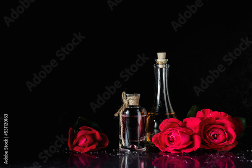 Perfume bottles and red roses.