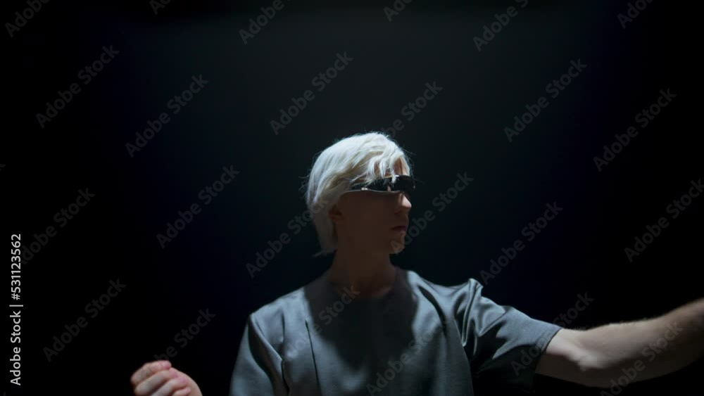 Guy touching virtual objects in futuristic glasses. Cyber player experiencing Guy touching virtual objects in futuristic glasses. Cyber player experiencing