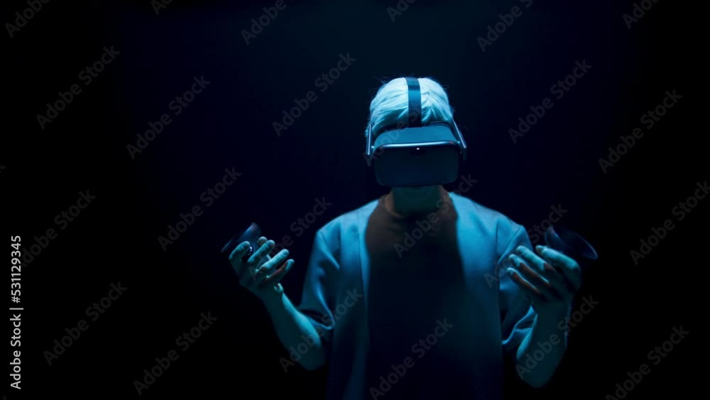 Neon gamer immersing virtual reality world in headset. Excited unknown man look Neon gamer immersing virtual reality world in headset. Excited unknown man look