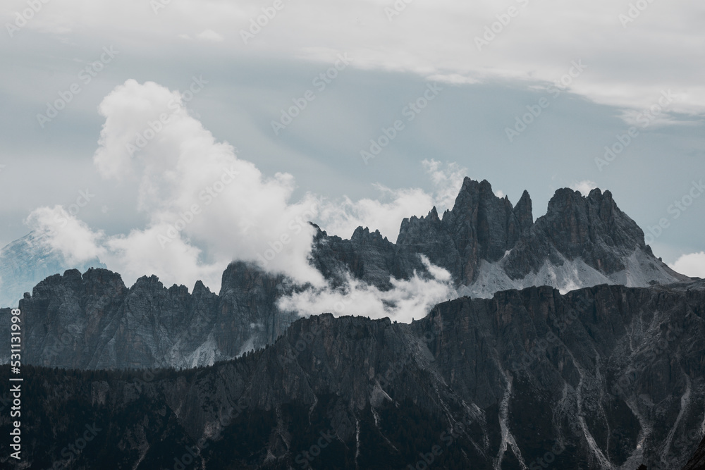 clouds over dolomtes mountains