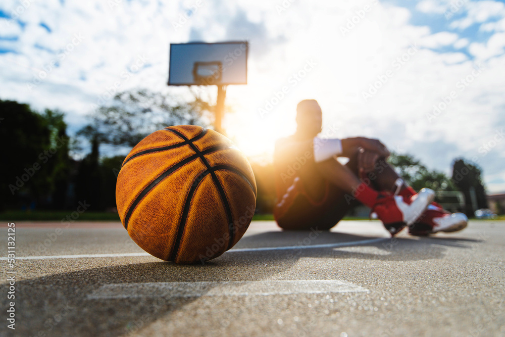 Foto Stock Basketball on street court - Basket ball player playing outdoor  - Sport lifestyle concept | Adobe Stock